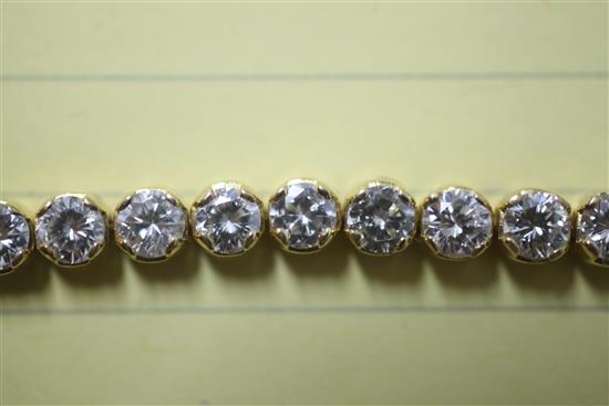 An 18ct gold and diamond line bracelet, 18cm.